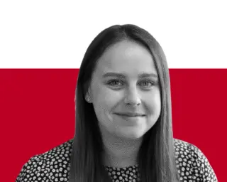 A black-and-white portrait of a woman with long straight hair, wearing a patterned blouse against a red-and-white background.