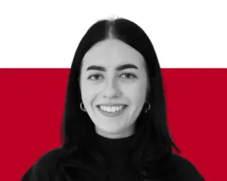 A portrait of a woman with dark hair wearing a black top, posed against a white and red background.