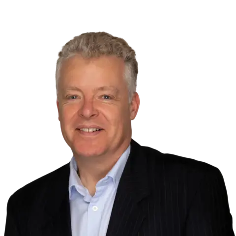 A middle-aged man with gray hair wearing a dark pinstripe suit and light blue shirt, shown against a black background.