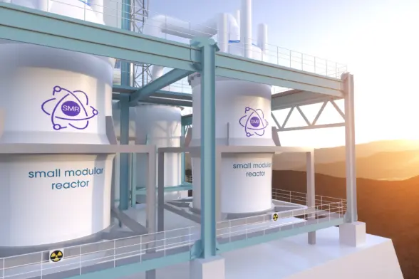 A modern small modular reactor (SMR) facility with large, white cylindrical containers featuring a logo. The structure is set against a backdrop of mountains and a sunset, highlighting the technological design.