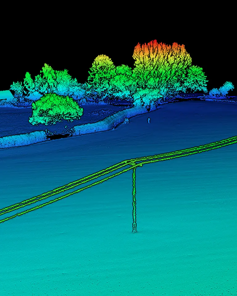 A digital elevation model depicting a landscape with a fence, trees, and a building, all represented in vibrant colors against a black background. Power lines run across the foreground.