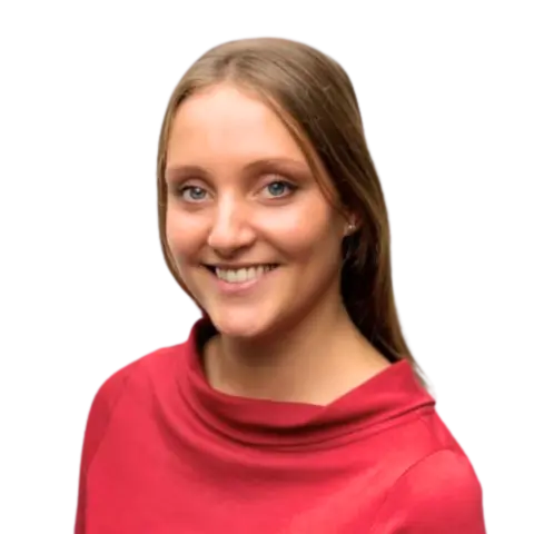 A smiling woman wearing a red top with a high collar is shown against a transparent background. She has long, straight hair and is facing slightly to the right.