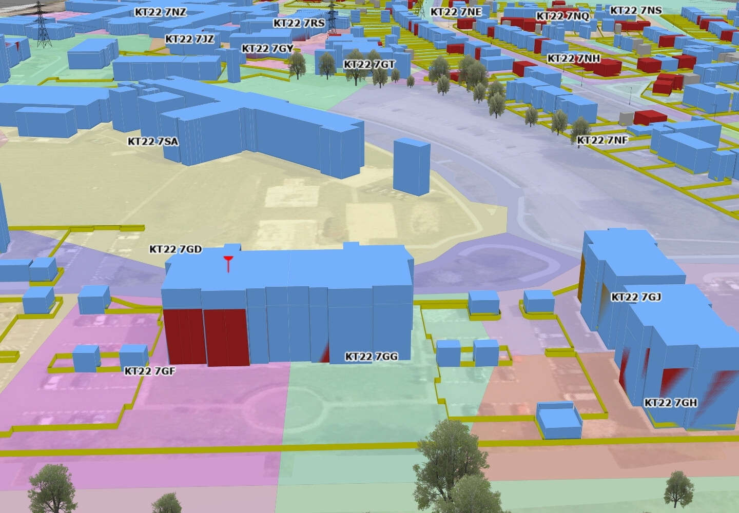 A 3D map view showing various buildings represented in different colors, including blue and pink, with labeled identifiers. The layout displays streets, green spaces, and clusters of structures in a detailed urban environment.